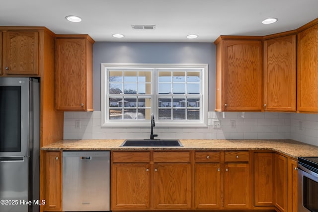 kitchen featuring sink, decorative backsplash, and stainless steel appliances