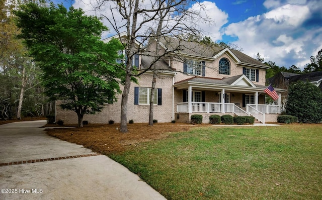 view of front facade with a porch and a front lawn