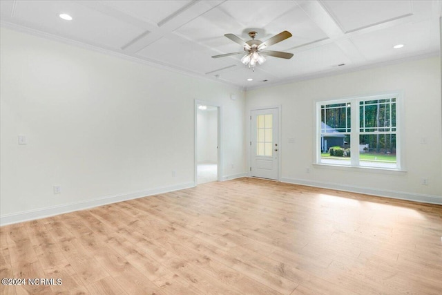 empty room with light hardwood / wood-style floors, ceiling fan, beam ceiling, ornamental molding, and coffered ceiling