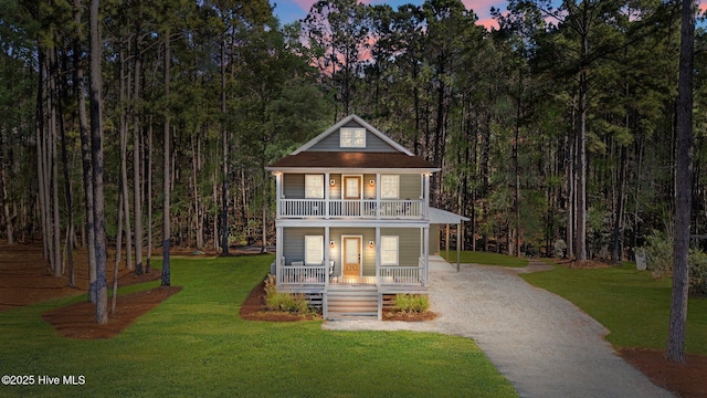 view of front of home with a yard and covered porch