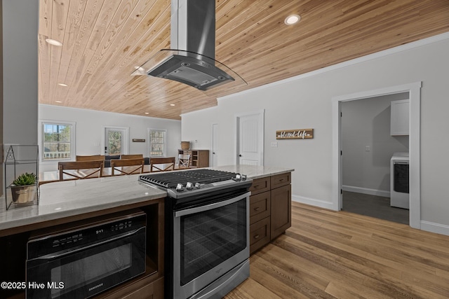 kitchen with light stone countertops, island range hood, stainless steel gas range oven, and wooden ceiling