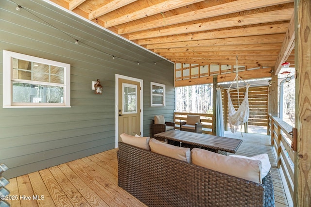 wooden terrace with an outdoor hangout area