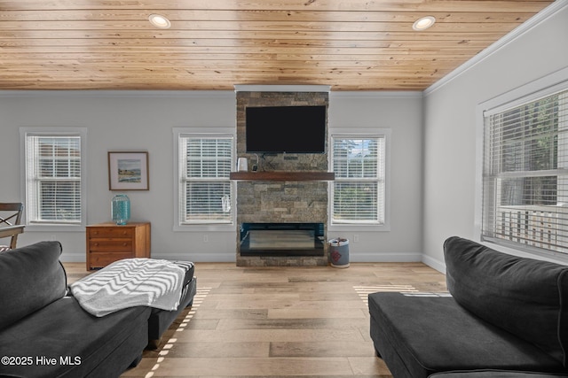 living room featuring a stone fireplace, ornamental molding, wooden ceiling, and light wood-type flooring