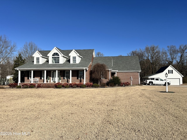 cape cod-style house with a front lawn and a porch