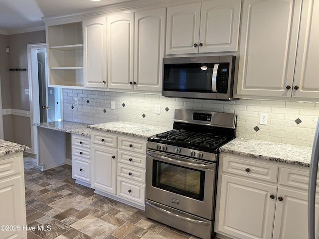 kitchen featuring appliances with stainless steel finishes, light stone counters, and white cabinetry