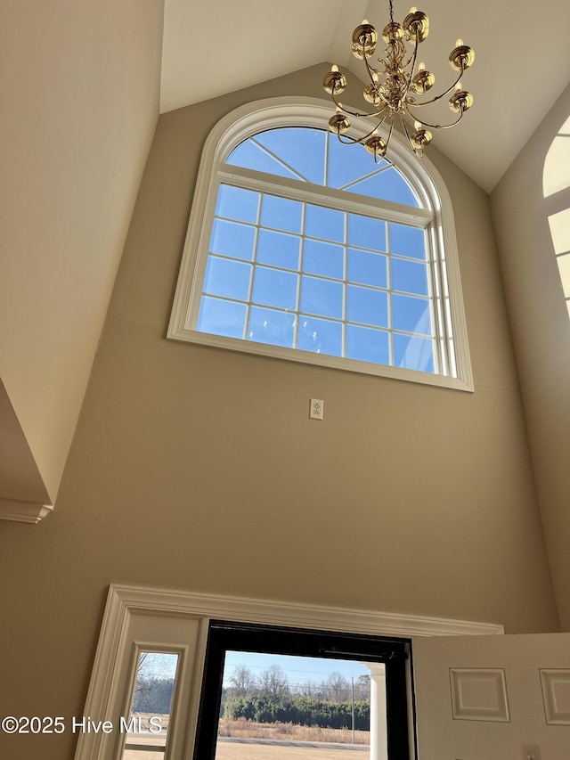 interior details featuring an inviting chandelier