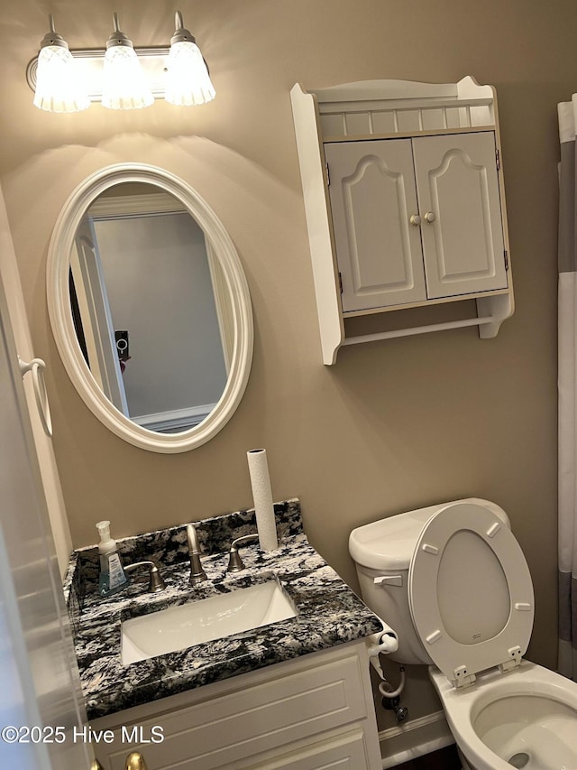 bathroom featuring toilet and vanity