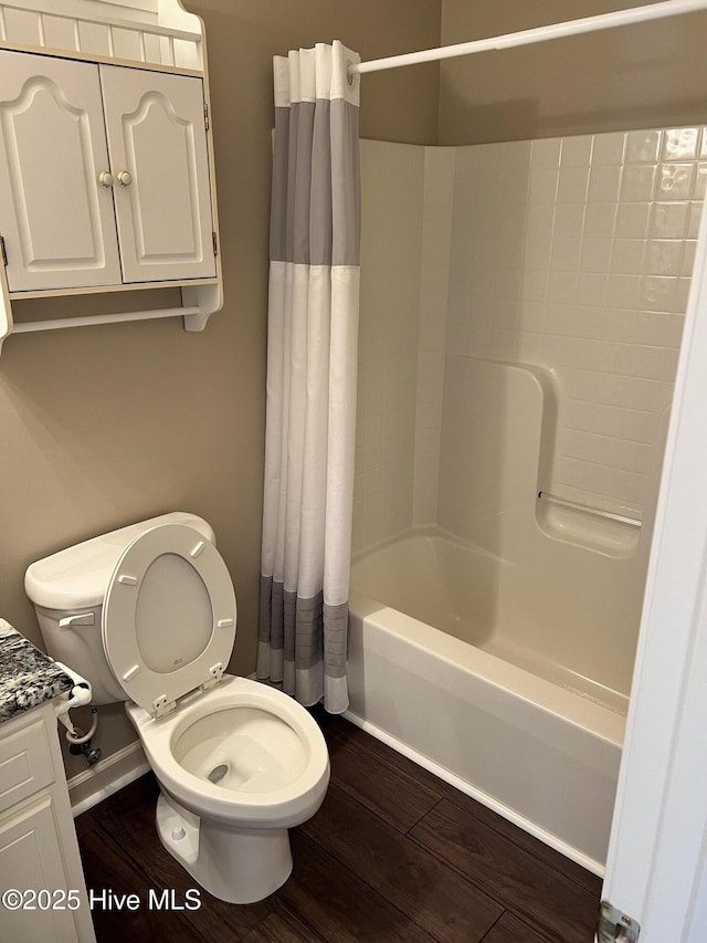 full bathroom with toilet, shower / tub combo, hardwood / wood-style flooring, and vanity