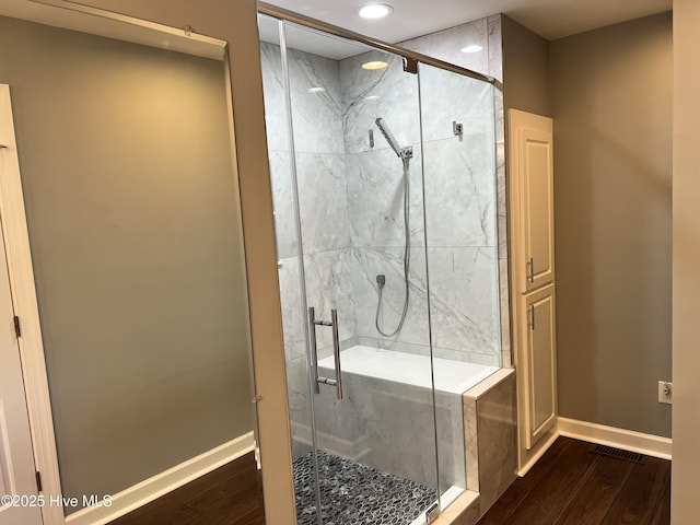 bathroom featuring a shower with door