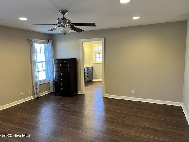 empty room featuring ceiling fan and dark hardwood / wood-style flooring