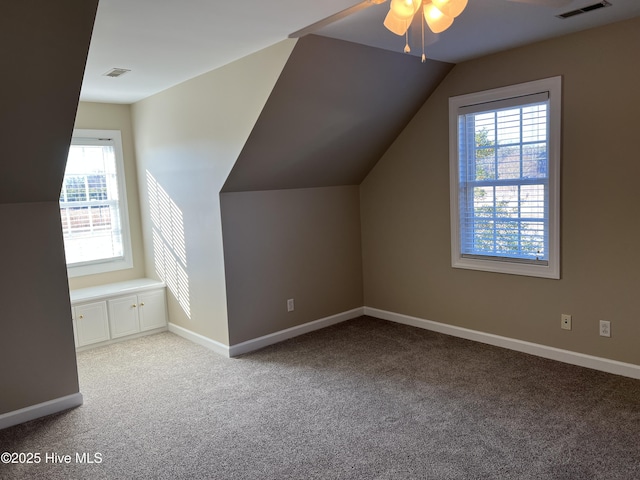 additional living space with light carpet, ceiling fan, and vaulted ceiling