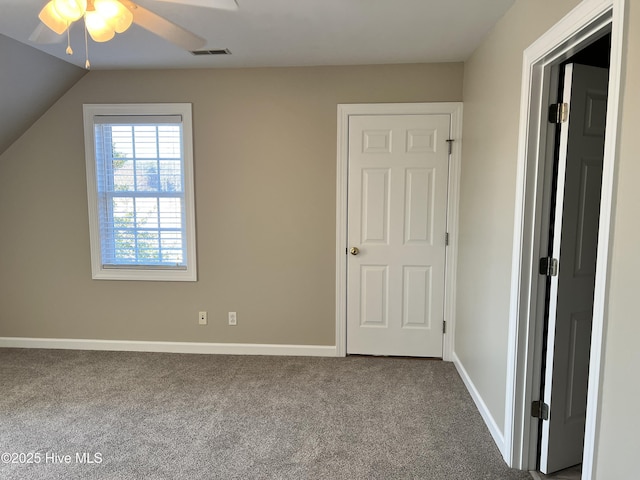 additional living space featuring ceiling fan, carpet, and lofted ceiling