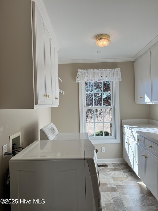 laundry area with cabinets, ornamental molding, and independent washer and dryer