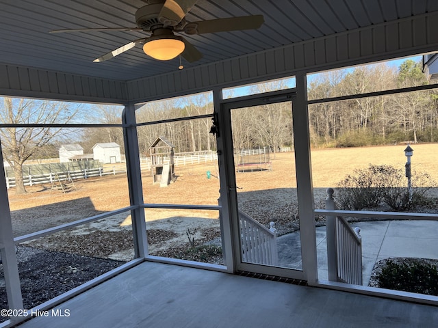 unfurnished sunroom featuring ceiling fan and wooden ceiling