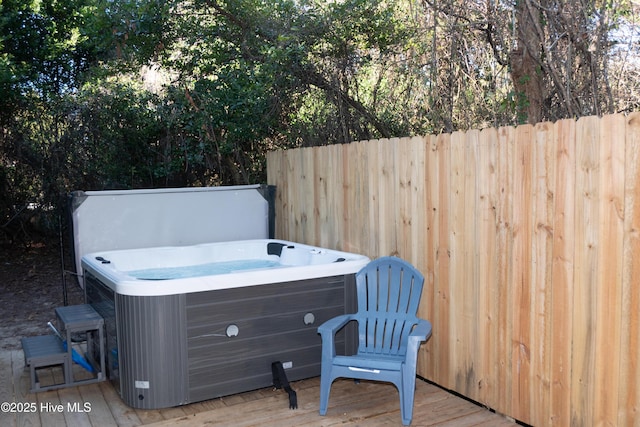 view of patio featuring a deck and a hot tub