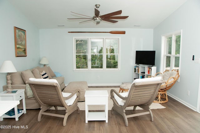 living room featuring light wood-type flooring, ceiling fan, and vaulted ceiling