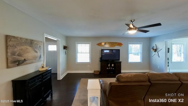 living room with dark wood-type flooring and ceiling fan