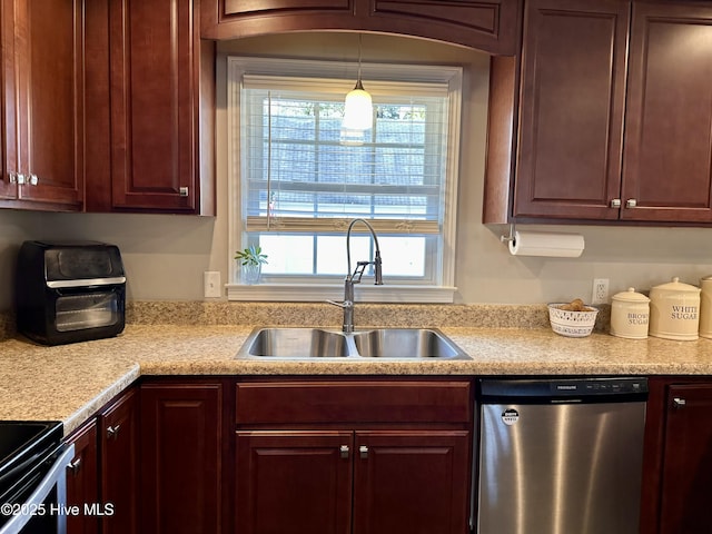 kitchen featuring sink, decorative light fixtures, stainless steel dishwasher, and plenty of natural light