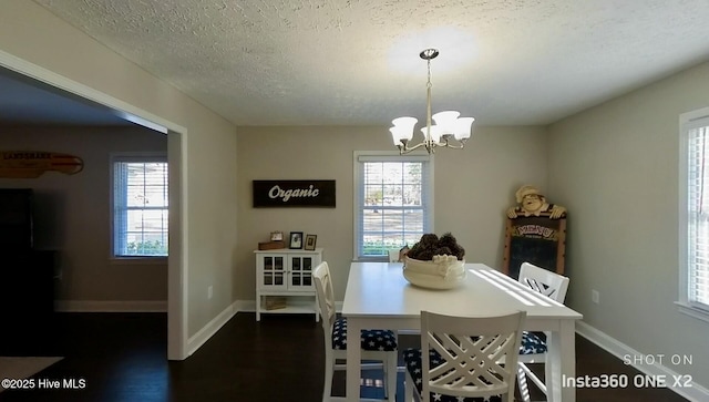 dining area featuring a textured ceiling and a notable chandelier