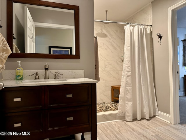 bathroom with vanity, curtained shower, and wood-type flooring