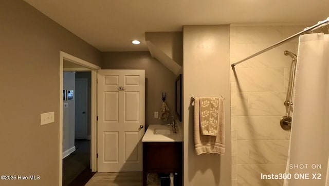 bathroom featuring vanity and curtained shower