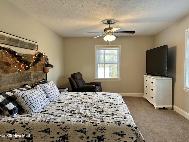 carpeted bedroom featuring a textured ceiling and ceiling fan