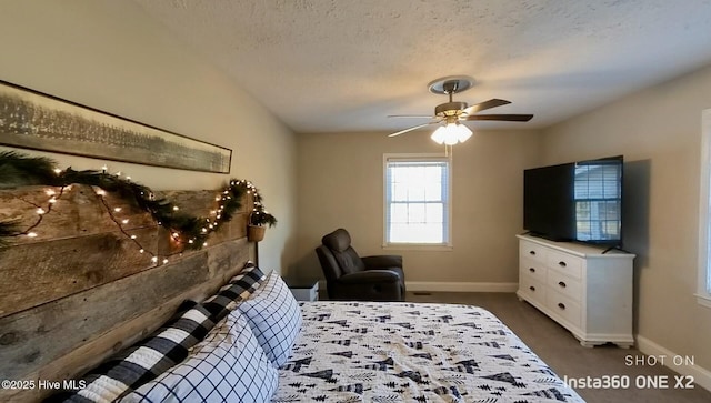 carpeted bedroom featuring a textured ceiling and ceiling fan