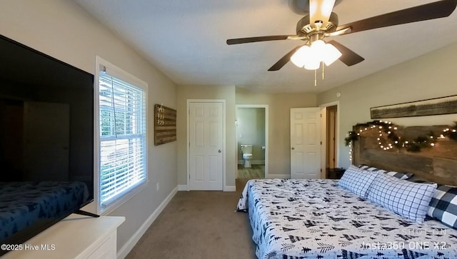 bedroom featuring carpet flooring, ceiling fan, and ensuite bath