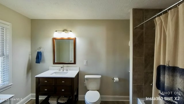 full bathroom with toilet, vanity, a textured ceiling, and shower / tub combo with curtain