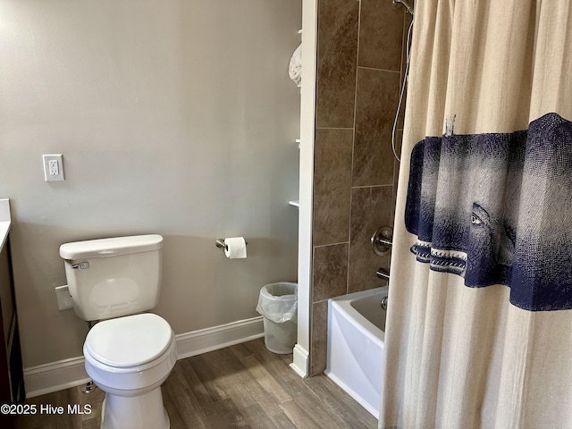 bathroom featuring shower / tub combo, hardwood / wood-style floors, and toilet