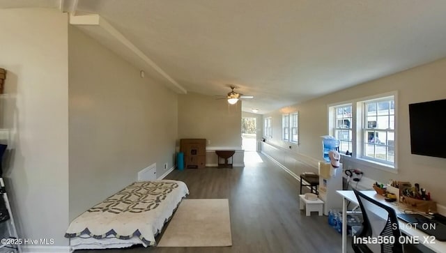 living room featuring ceiling fan, vaulted ceiling, and wood-type flooring