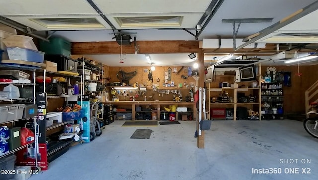 garage with a garage door opener and a workshop area