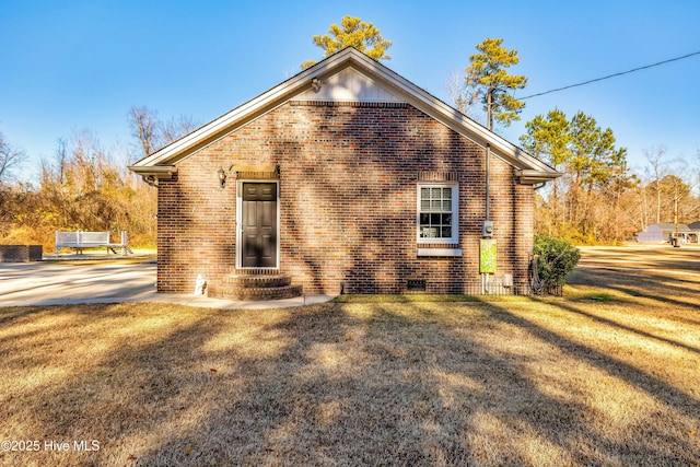 rear view of property featuring a yard