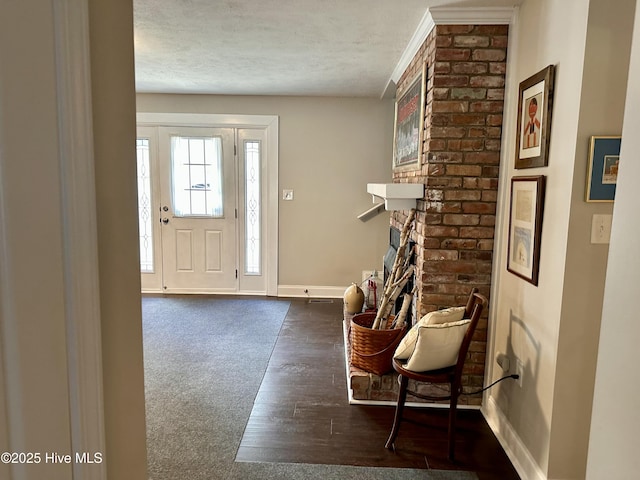 carpeted entrance foyer with a textured ceiling and a fireplace