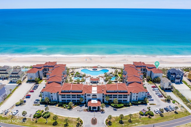 birds eye view of property featuring a view of the beach and a water view