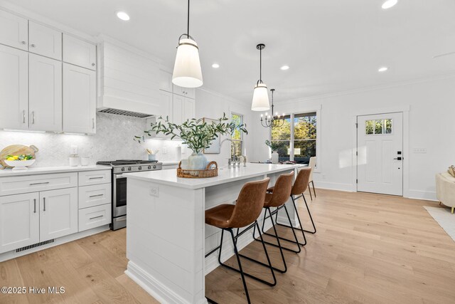 dining room with a notable chandelier, light hardwood / wood-style floors, and crown molding