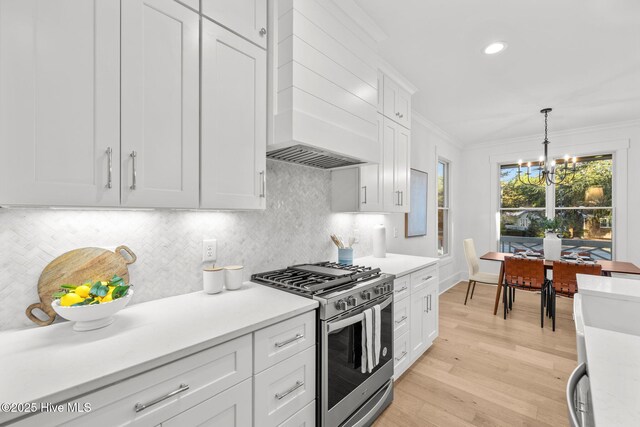 kitchen featuring appliances with stainless steel finishes, pendant lighting, white cabinets, and ceiling fan