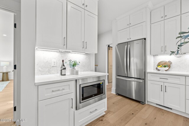 kitchen featuring ornamental molding, pendant lighting, white cabinets, an inviting chandelier, and gas range