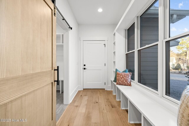 mudroom with built in shelves and plenty of natural light