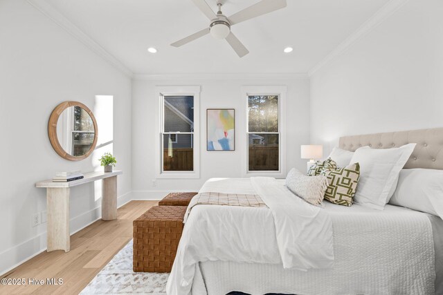 bedroom with connected bathroom, ceiling fan, light wood-type flooring, and crown molding