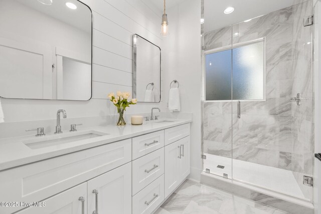 bathroom with toilet, vanity, and a shower with shower door