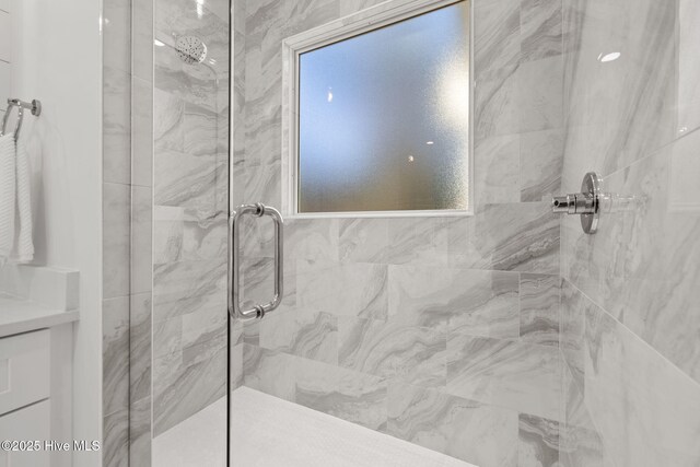 bathroom featuring an enclosed shower and vanity