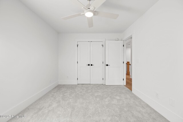 unfurnished room featuring ceiling fan and light carpet