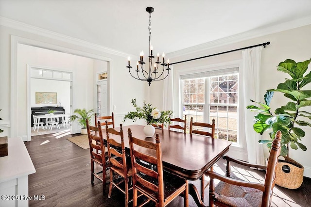 dining area featuring dark hardwood / wood-style floors, an inviting chandelier, and ornamental molding