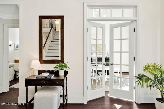 entryway featuring ornamental molding, dark hardwood / wood-style flooring, and french doors