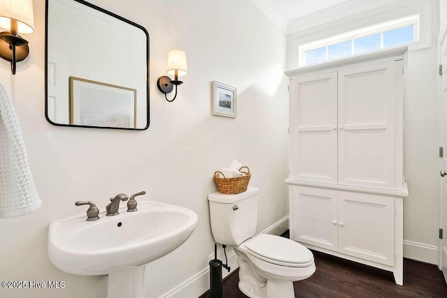 bathroom featuring sink, hardwood / wood-style floors, toilet, and crown molding