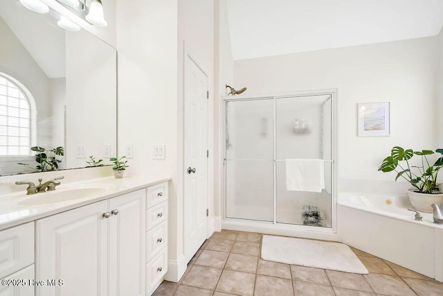 bathroom with lofted ceiling, tile patterned floors, separate shower and tub, and vanity