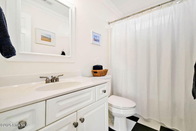 bathroom featuring toilet, vanity, and crown molding