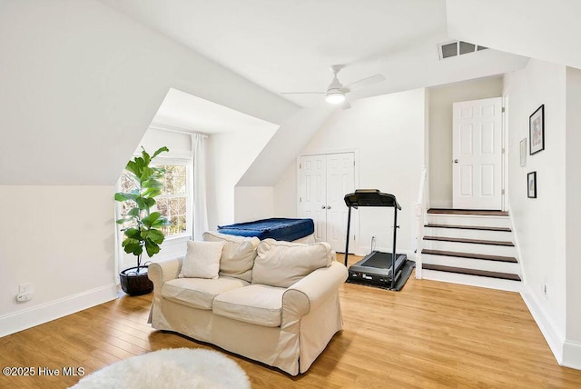 living area featuring ceiling fan, lofted ceiling, and hardwood / wood-style floors