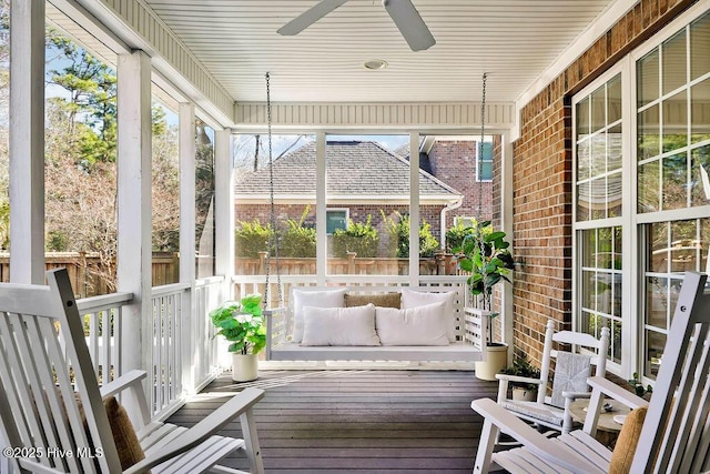 unfurnished sunroom featuring ceiling fan